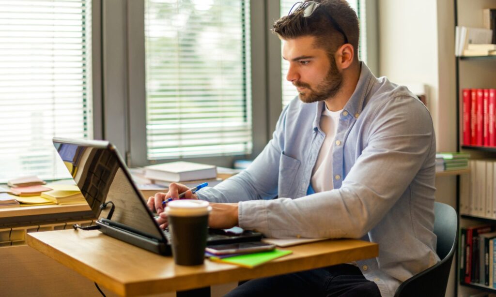 A man on a laptop taking an online training course