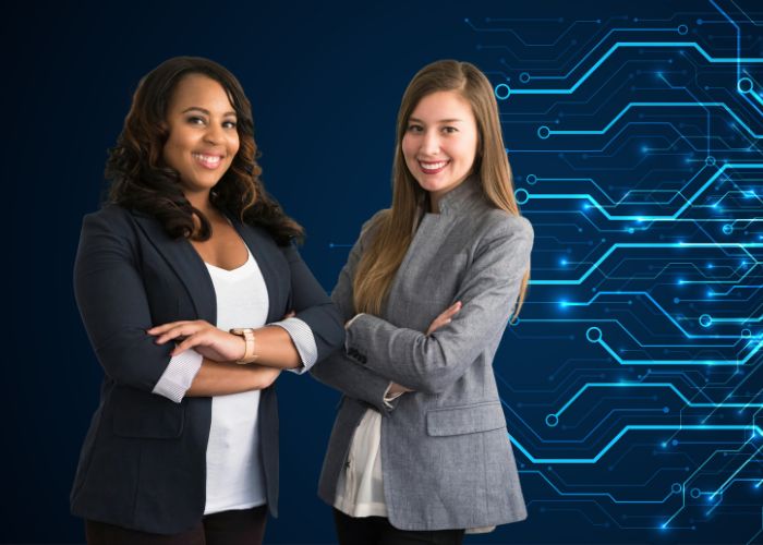 Two professional women standing in front of a conceptual tech background