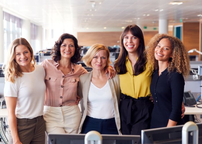 Five women in a corporate/office setting